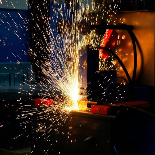 Vibrant display of welding sparks in an industrial setting, highlighting manufacturing processes.