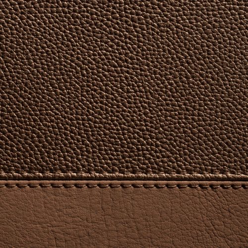 High-resolution image of brown leather texture with visible seam detail.